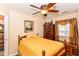 Comfortable bedroom featuring a wood bed frame, ceiling fan, and natural light at 915 Prestwick Dr # D, Indianapolis, IN 46214
