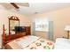 Comfortable bedroom with a wooden four-poster bed, neutral walls, and good natural light at 915 Prestwick Dr # D, Indianapolis, IN 46214
