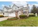 Charming townhome featuring a brick facade, well-kept lawn, and inviting front entrance with tasteful landscaping at 915 Prestwick Dr # D, Indianapolis, IN 46214