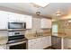 Bright kitchen boasts stainless appliances, double sink, granite counters and updated subway tile backsplash at 915 Prestwick Dr # D, Indianapolis, IN 46214