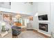 Bright living room featuring a vaulted ceiling, cozy fireplace, and open staircase at 915 Prestwick Dr # D, Indianapolis, IN 46214