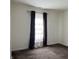 Bright bedroom featuring neutral walls, plush carpeting, and a window with decorative curtains at 10890 Poppy Hill Dr, Indianapolis, IN 46234