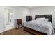 Bedroom with neutral carpet, dark wood furniture and an ensuite bathroom with glass shower at 10890 Poppy Hill Dr, Indianapolis, IN 46234