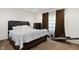Carpeted bedroom featuring a dark wood platform bed, matching furniture, and natural light at 10890 Poppy Hill Dr, Indianapolis, IN 46234