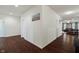 Hallway with clean white walls and rich dark hardwood flooring at 10890 Poppy Hill Dr, Indianapolis, IN 46234