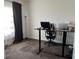 Home office featuring a dark hardwood desk, neutral carpet and large window at 10890 Poppy Hill Dr, Indianapolis, IN 46234