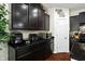 Modern kitchen with granite countertops, dark wood cabinets, and stainless steel appliances at 10890 Poppy Hill Dr, Indianapolis, IN 46234