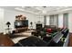 Living room with fireplace, coffered ceiling, modern furnishings, a large screen TV, and statement decor at 10890 Poppy Hill Dr, Indianapolis, IN 46234