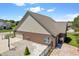 Back exterior of a brick house showing the backyard, patio, and roof with a brick and gravel foundation at 10890 Poppy Hill Dr, Indianapolis, IN 46234