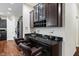 Dry bar area with stylish cabinetry, wine rack, and bar stool seating, perfect for entertaining guests at 10890 Poppy Hill Dr, Indianapolis, IN 46234