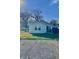Back exterior view shows a well-kept yard with an outdoor grill and a partial view of a boat at 1133 S Kealing Ave, Indianapolis, IN 46203