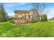 Well-maintained backyard with a spacious deck, a charming pergola, and lush green grass at 11367 Zanardi Ct, Zionsville, IN 46077