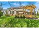Beautiful backyard featuring a spacious back deck, a pergola, and lush landscaping at 11367 Zanardi Ct, Zionsville, IN 46077