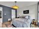 Well-lit bedroom features modern decor, a comfortable bed, and stylish accents creating a serene space at 11367 Zanardi Ct, Zionsville, IN 46077