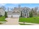 Stunning two-story home with a three-car garage and manicured lawn at 11367 Zanardi Ct, Zionsville, IN 46077