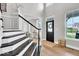 Elegant foyer with hardwood floors and staircase leading to the upper level at 11367 Zanardi Ct, Zionsville, IN 46077
