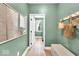Hallway with an open door to the laundry room, and framed artwork at 11367 Zanardi Ct, Zionsville, IN 46077
