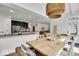 Kitchen and dining area features granite countertops, stainless steel appliances and a pendant light fixture at 11367 Zanardi Ct, Zionsville, IN 46077