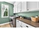 Bright laundry room featuring white cabinets, stainless steel washer and dryer, and a window with natural light at 11367 Zanardi Ct, Zionsville, IN 46077