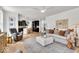 Open concept living room flows into kitchen with hardwood floors, neutral tones and lots of natural light at 11367 Zanardi Ct, Zionsville, IN 46077