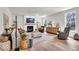 Inviting living room with a fireplace, hardwood floors, neutral tones and picture windows at 11367 Zanardi Ct, Zionsville, IN 46077