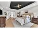 Inviting main bedroom with wood floors, a unique ceiling, and multiple entry points to other rooms at 11367 Zanardi Ct, Zionsville, IN 46077