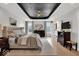 Spacious main bedroom featuring hardwood floors, detailed tray ceiling, and modern decor at 11367 Zanardi Ct, Zionsville, IN 46077