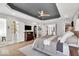 Bright main bedroom featuring wood floors, modern ceiling, and entrances to the closet and bath at 11367 Zanardi Ct, Zionsville, IN 46077