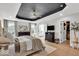 Comfortable main bedroom with a stylish ceiling, wood floors, and views into the bathroom and closet at 11367 Zanardi Ct, Zionsville, IN 46077