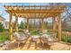 Back deck featuring a beautiful pergola with comfortable seating perfect for relaxing and entertaining at 11367 Zanardi Ct, Zionsville, IN 46077