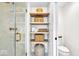 Sleek shower showcasing a glass door, open shelving, and modern fixtures for a spa-like experience at 11367 Zanardi Ct, Zionsville, IN 46077