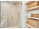 Modern shower featuring a glass enclosure, rainfall showerhead, and built-in shelves for storage at 11367 Zanardi Ct, Zionsville, IN 46077