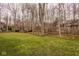 Grassy backyard featuring a sprawling lawn, mature trees, and a private wooded area at 11691 Diamond Pointe Ct, Indianapolis, IN 46236