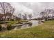 Scenic view of the backyard with waterfront access, a boat house and dock at 11691 Diamond Pointe Ct, Indianapolis, IN 46236