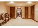 Basement area with carpeted floors, trimwork, and a hallway visible through open double doors at 11691 Diamond Pointe Ct, Indianapolis, IN 46236