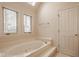 Soaking tub with natural light from windows in bright and airy bathroom at 11691 Diamond Pointe Ct, Indianapolis, IN 46236