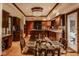 Kitchen and dinette space features custom wood cabinets, hardwood floors and breakfast bar at 11691 Diamond Pointe Ct, Indianapolis, IN 46236