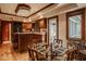 View of the kitchen and dinette area featuring custom wood cabinets and breakfast bar at 11691 Diamond Pointe Ct, Indianapolis, IN 46236