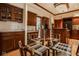 A stylish eat-in kitchen area features beautiful wood cabinetry and glass dining table at 11691 Diamond Pointe Ct, Indianapolis, IN 46236