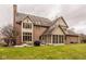 Back exterior view of home, with patio, well-maintained lawn and screened in porch at 11691 Diamond Pointe Ct, Indianapolis, IN 46236