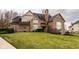 Stately brick home with an expansive front lawn, showcasing classic architecture and mature landscaping at 11691 Diamond Pointe Ct, Indianapolis, IN 46236