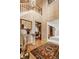 Elegant foyer with wood floors, open staircase, and decorative glass table with column base at 11691 Diamond Pointe Ct, Indianapolis, IN 46236