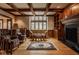 Spacious living room with a fireplace, coffered ceilings, and natural light from large windows at 11691 Diamond Pointe Ct, Indianapolis, IN 46236