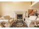 Bright living room with fireplace, neutral décor, and open staircase in background at 11691 Diamond Pointe Ct, Indianapolis, IN 46236