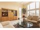 Bright living room featuring a large window, display cabinets, and neutral decor, creating a welcoming atmosphere at 11691 Diamond Pointe Ct, Indianapolis, IN 46236