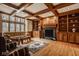 Cozy living room with a coffered ceiling, fireplace, and built-in shelving, creating a warm and inviting space at 11691 Diamond Pointe Ct, Indianapolis, IN 46236