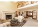 Spacious living room featuring a soaring ceiling, fireplace, and open layout to an adjacent living area at 11691 Diamond Pointe Ct, Indianapolis, IN 46236