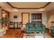 Open-concept living space with wet bar, wood floors, coffered ceiling and neutral wall paint at 11691 Diamond Pointe Ct, Indianapolis, IN 46236