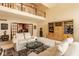 Open-concept living room with a balcony, fireplace, and large windows, offering ample natural light and space at 11691 Diamond Pointe Ct, Indianapolis, IN 46236