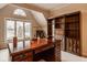 Home office with built in bookshelves, desk and view of the water at 11691 Diamond Pointe Ct, Indianapolis, IN 46236